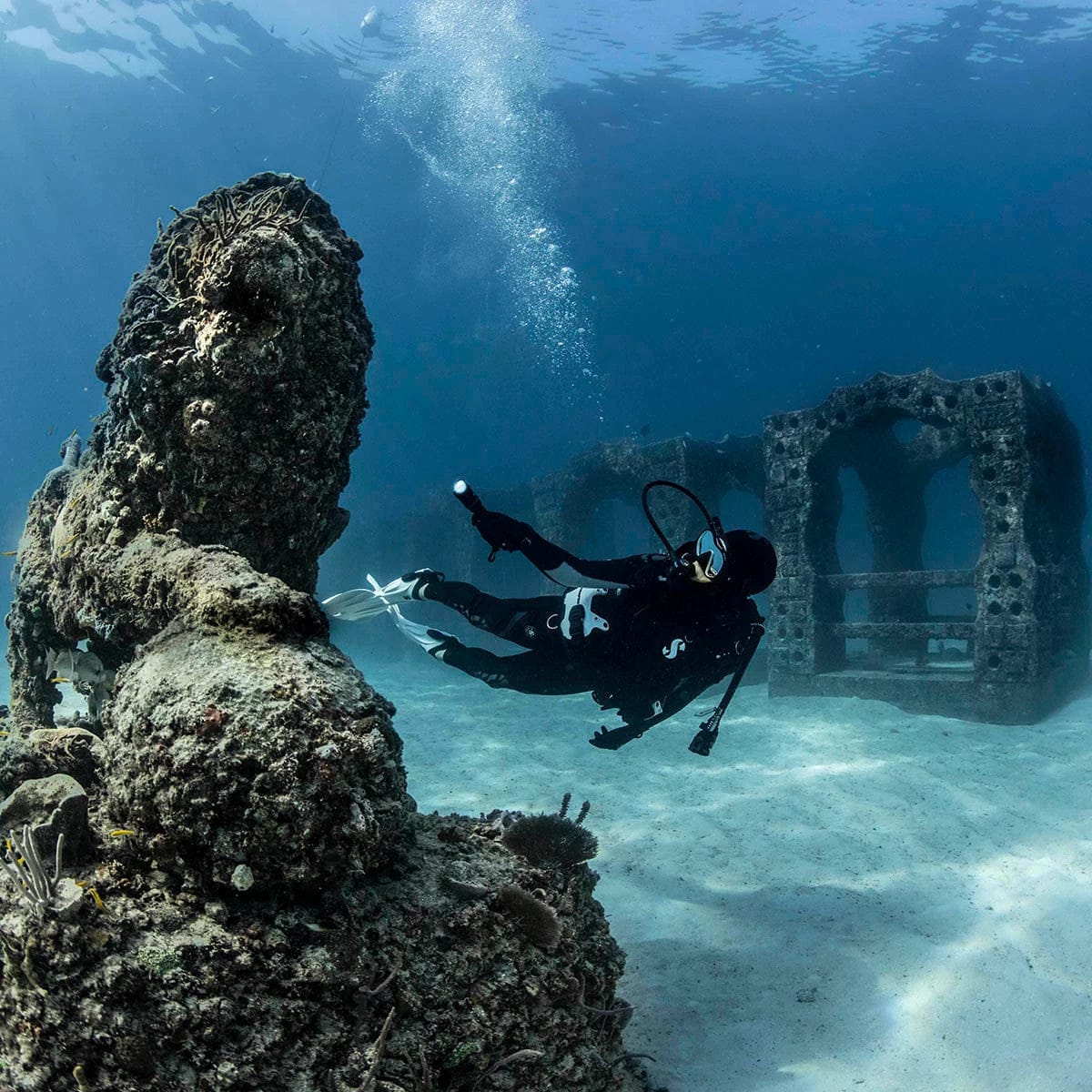 Underwater diver exploring Nova 850 Tec 05 reef structures.