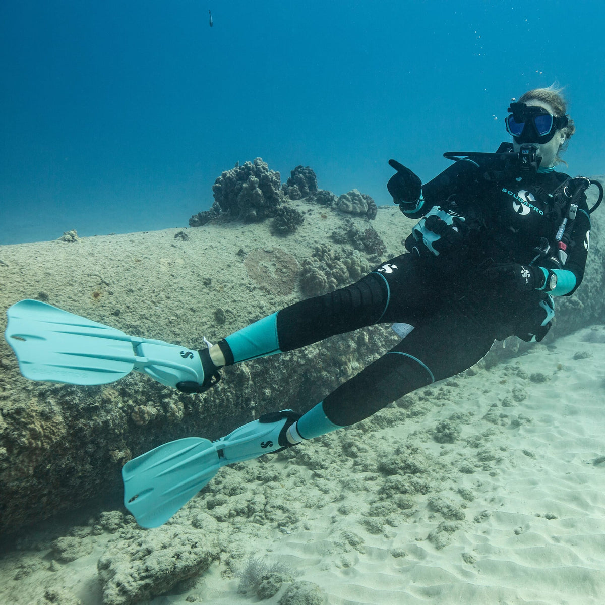 Scuba diver in 3mm Sport Steamer pointing underwater