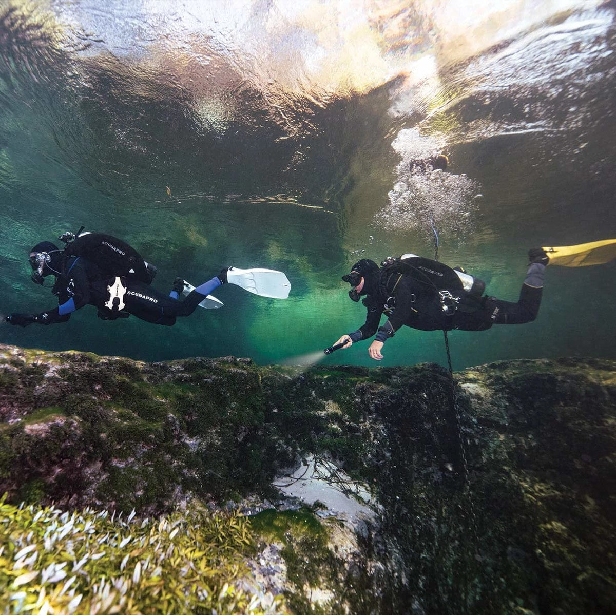 Two divers exploring underwater with S-Tek Donut 40 equipment.