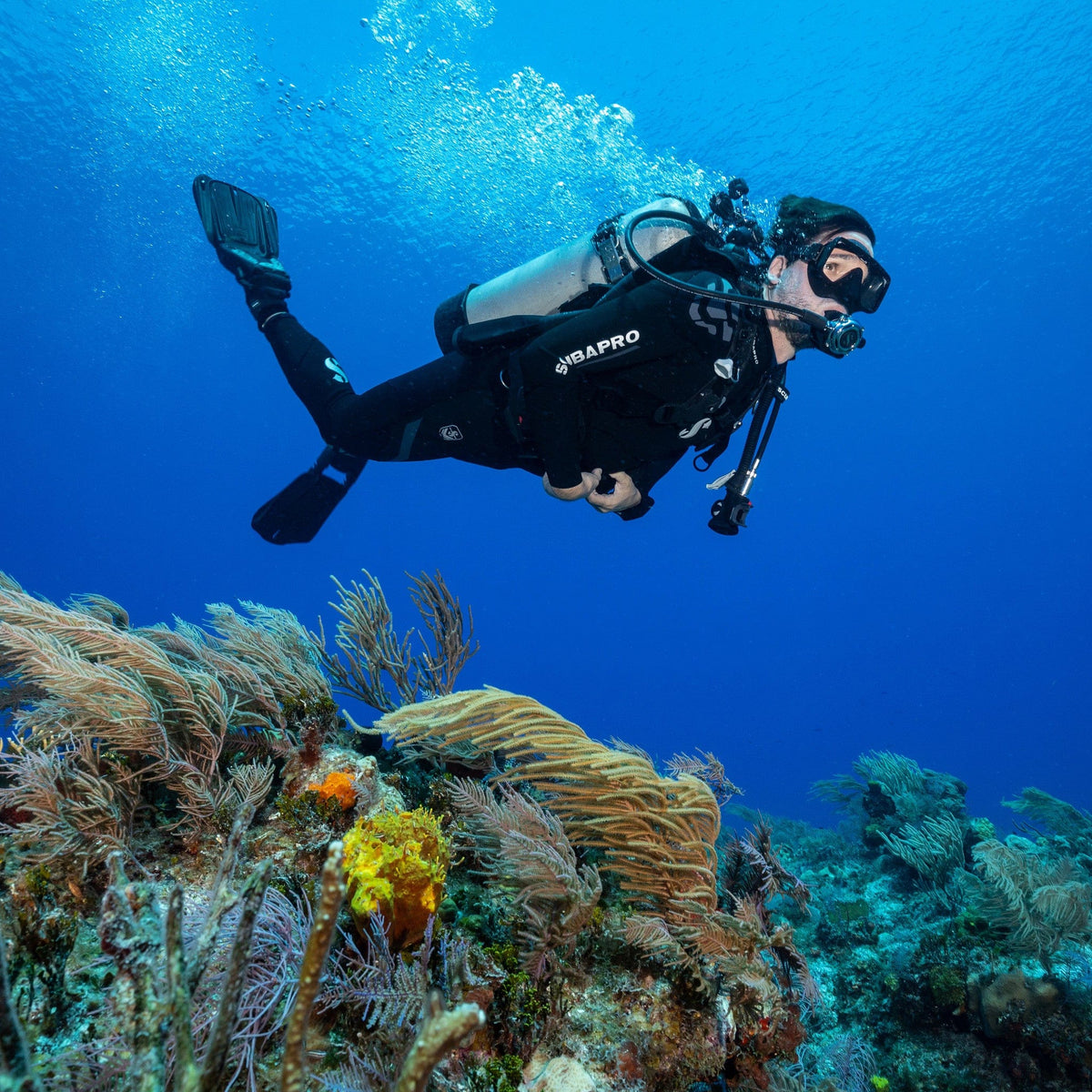 ScubaPro Seawing Supernova diver exploring coral reef