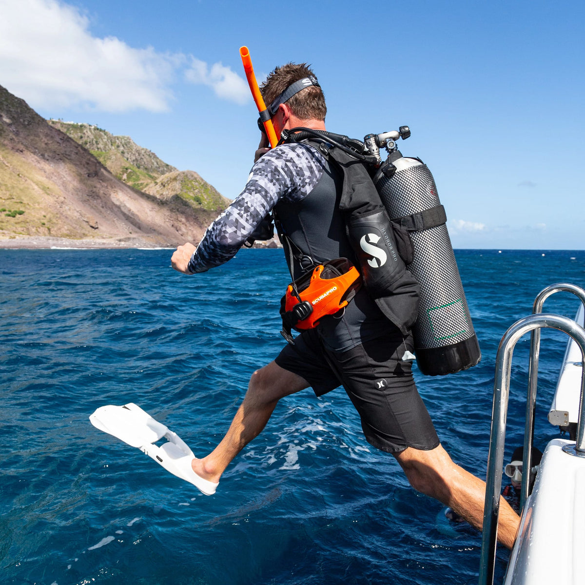 Scuba diver jumping into the ocean with Seawing Supernova gear