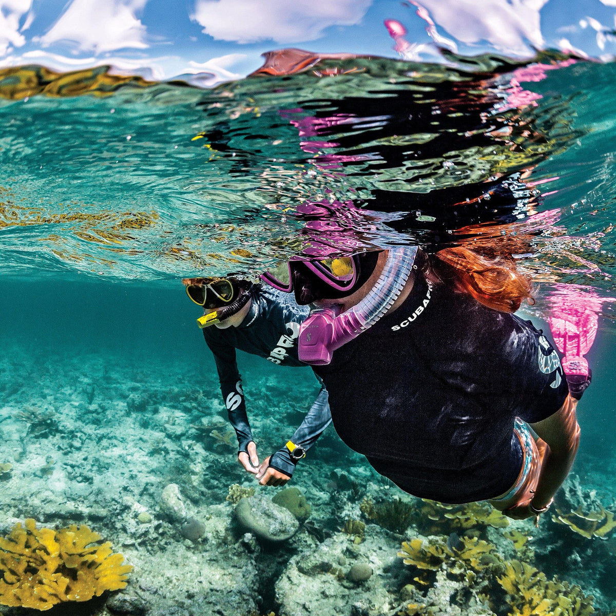 Snorkelers explore coral reef with Spectra snorkel