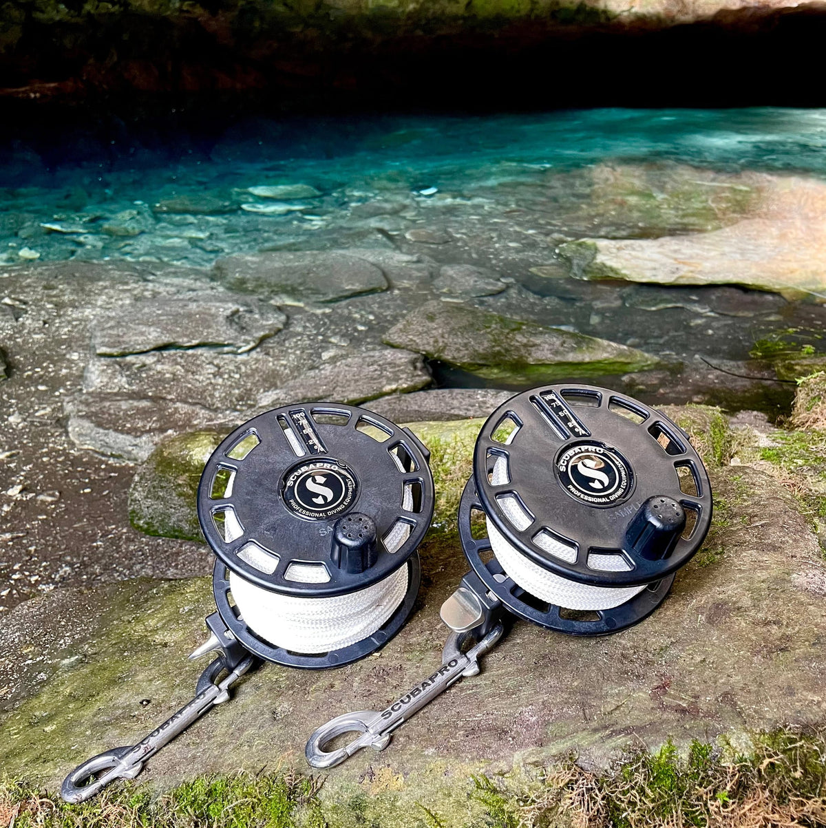 SP Expedition Reel 4, two reels near turquoise water.