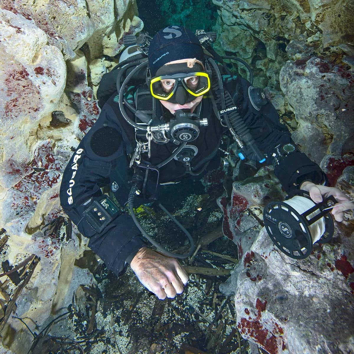 Scuba diver exploring cave with S-Tek Expedition Reel.
