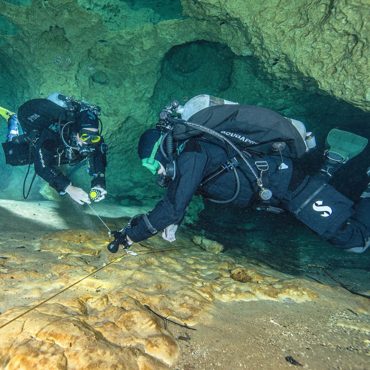 Two divers exploring underwater cave