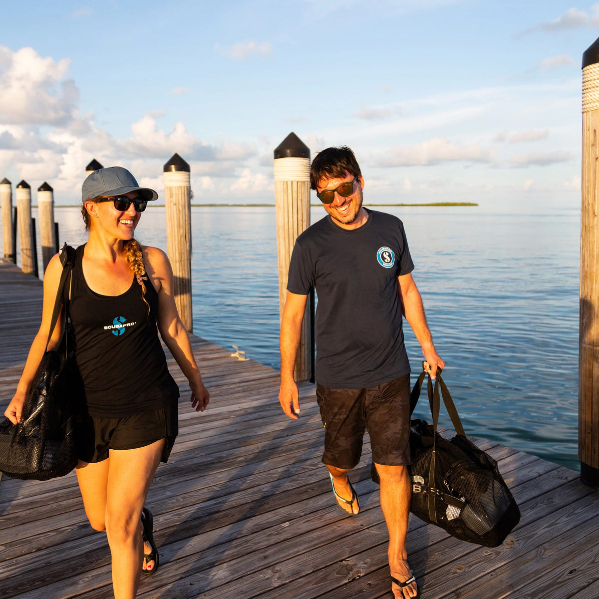 Diver T-shirt couple walking on pier.
