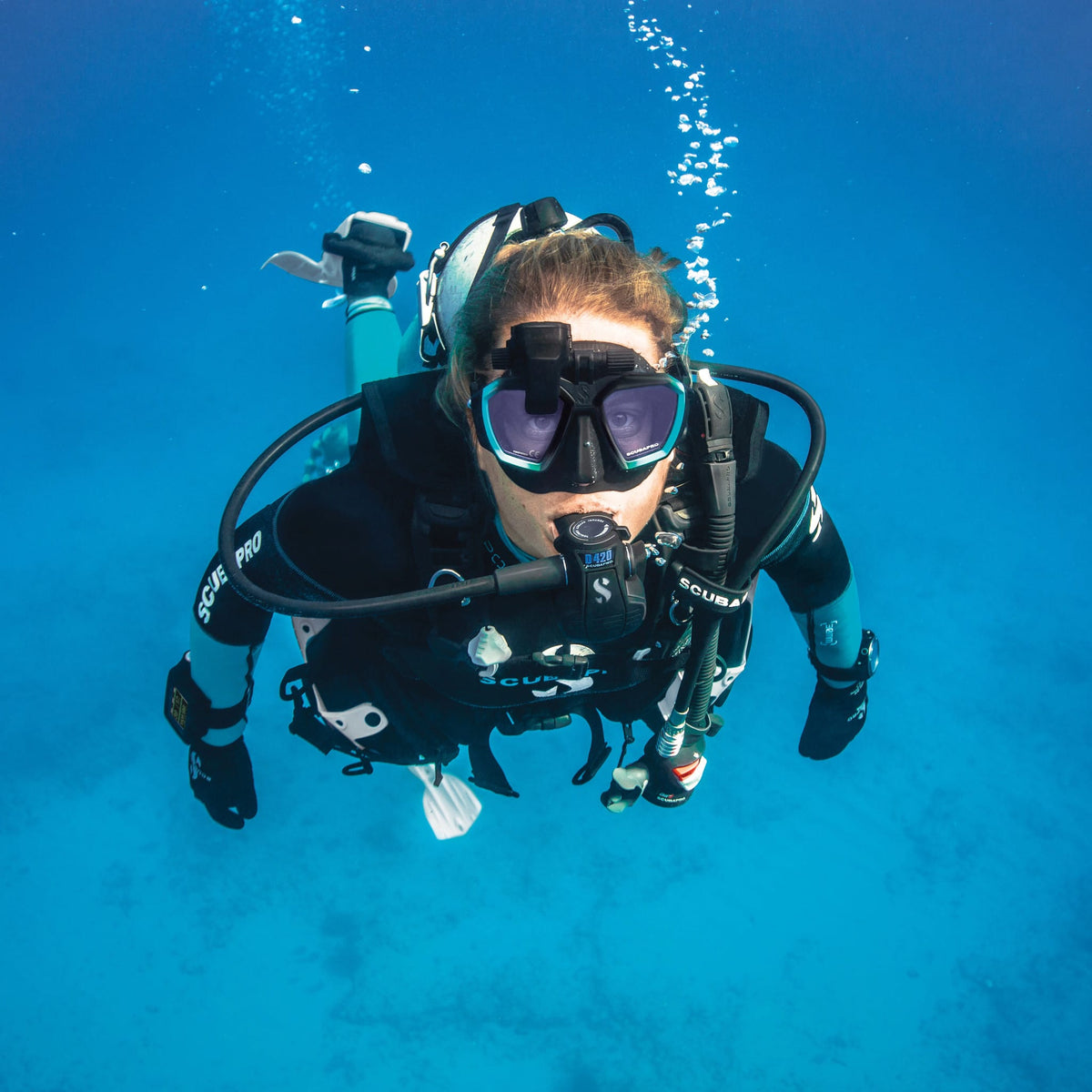 Scuba diver wearing Sport Steamer 3MM wetsuit in blue water