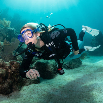 Woman scuba diving in 3MM Yulex top