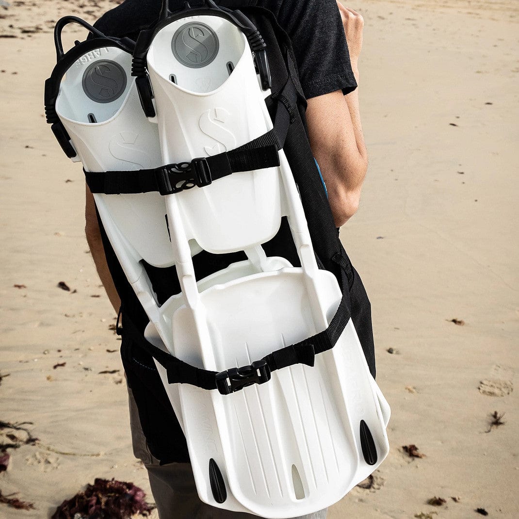 BCD carry bag with fins on person at beach
